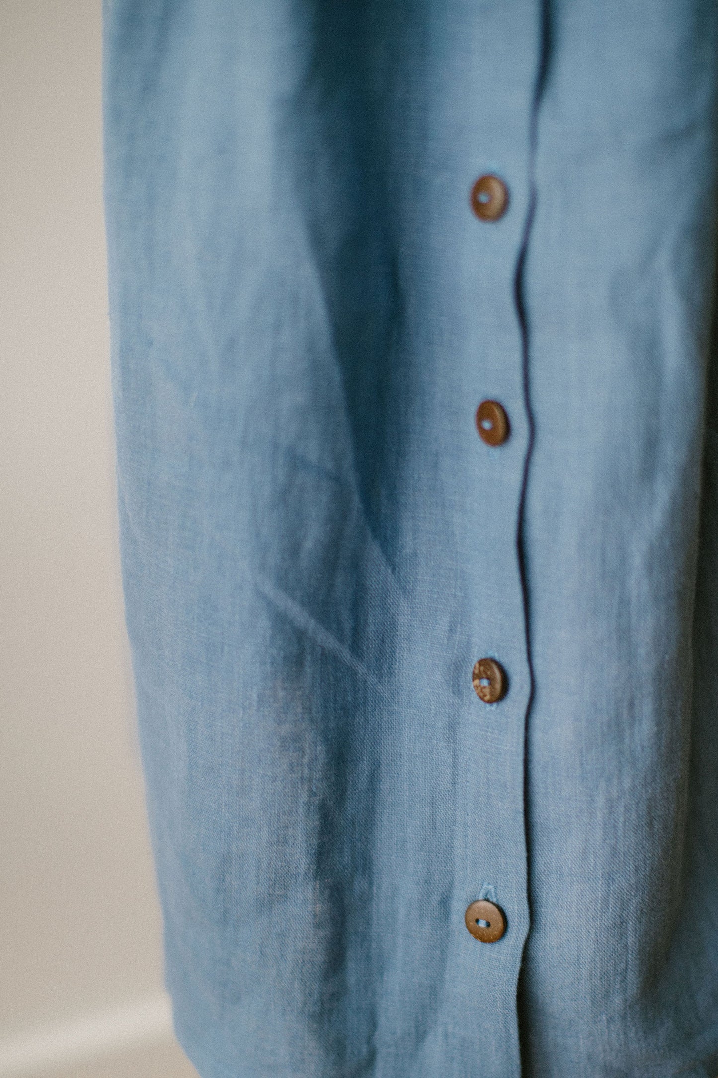 Beautiful light blue linen dress decorated with crocheted flowers