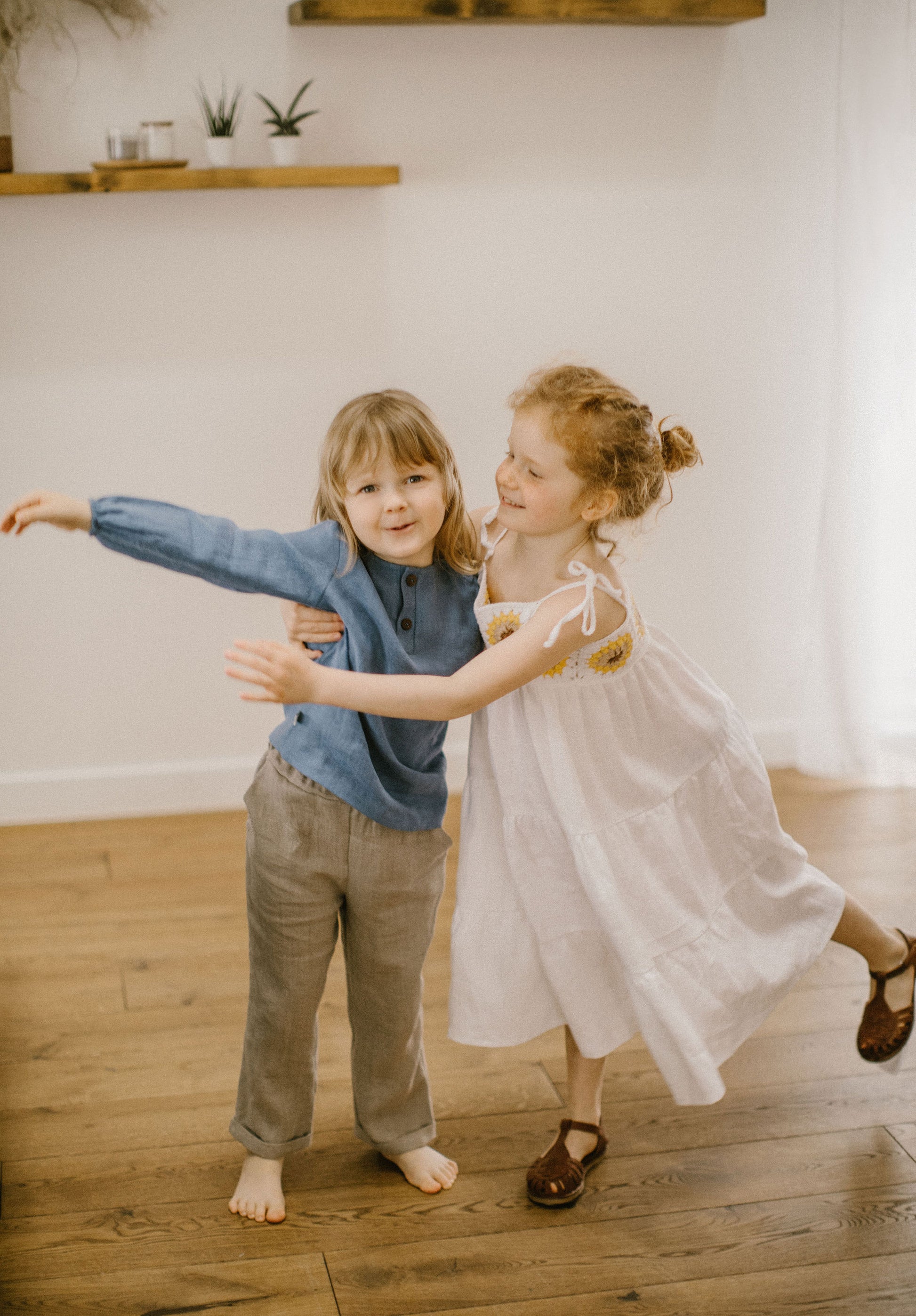 Beautiful girl's white linen dress with crochet sunflowers